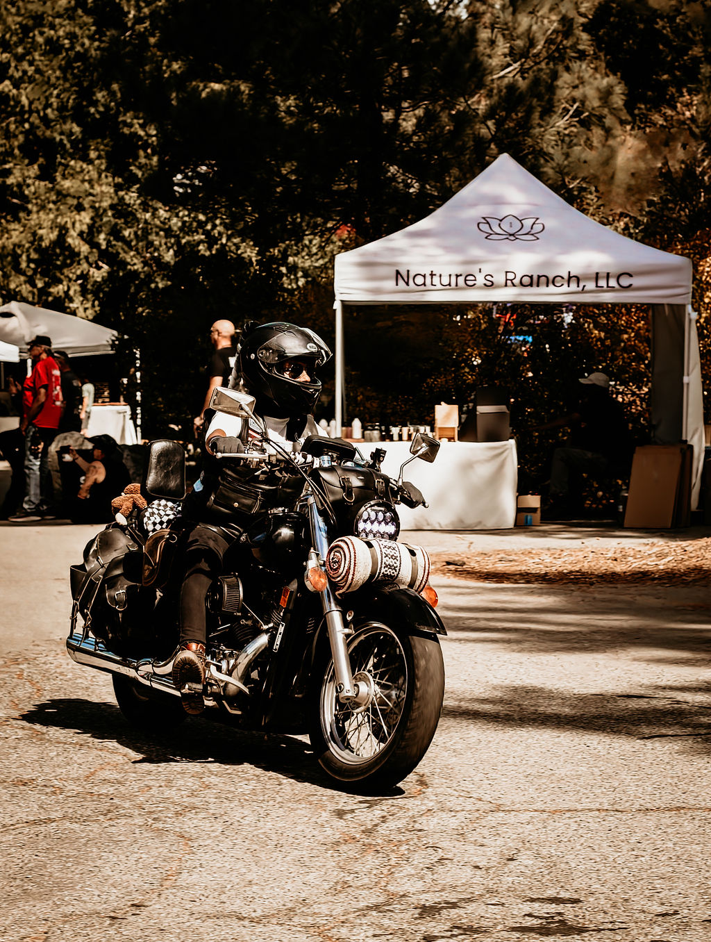 Rider cruising past the vendor tents at On The Mountain