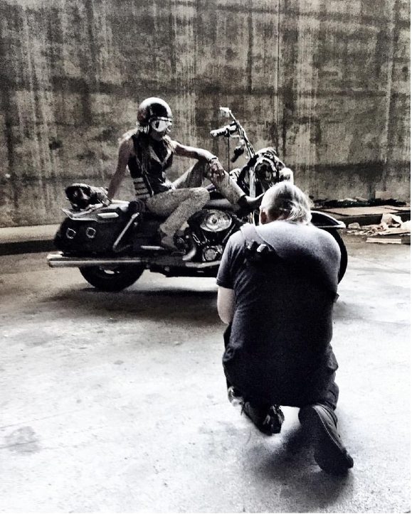 Black-and-white photo of Gevin with her motorcycle and a fellow rider