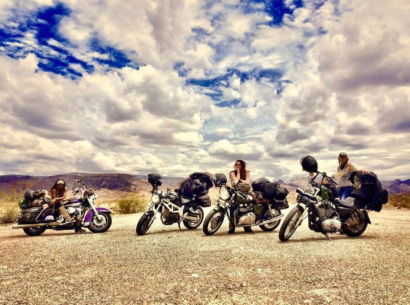 Motorcycles lined up under a big desert sky